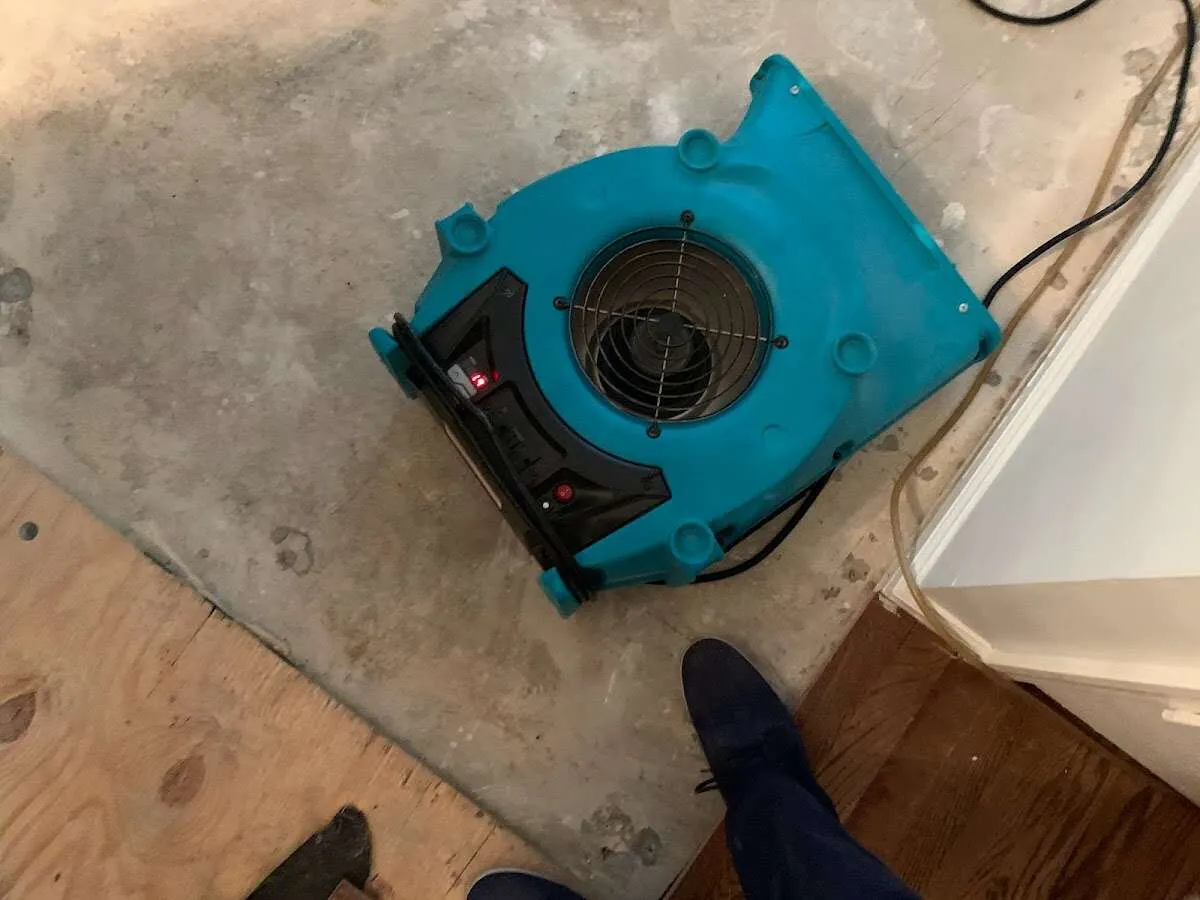 Air mover drying subfloor during Commercial Water Damage Restoration in Jaffrey